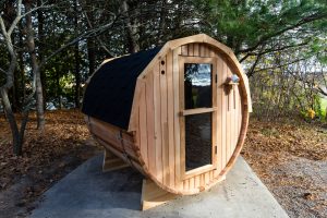 Beautiful outdoor barrel sauna and grill in michigan