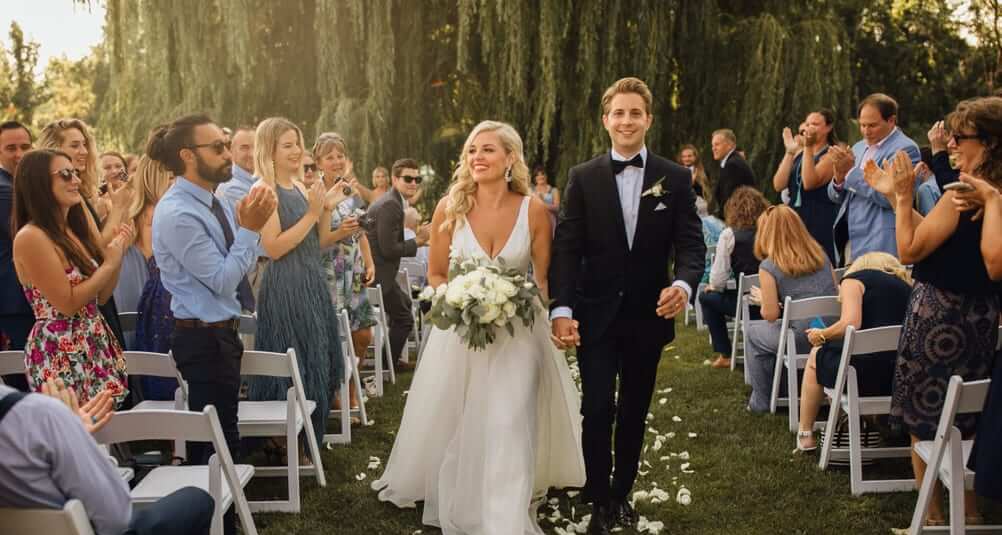 Couple walking down the aisle at a wedding ceremony at Aurora Cellars, Lake Leelanau, Michigan