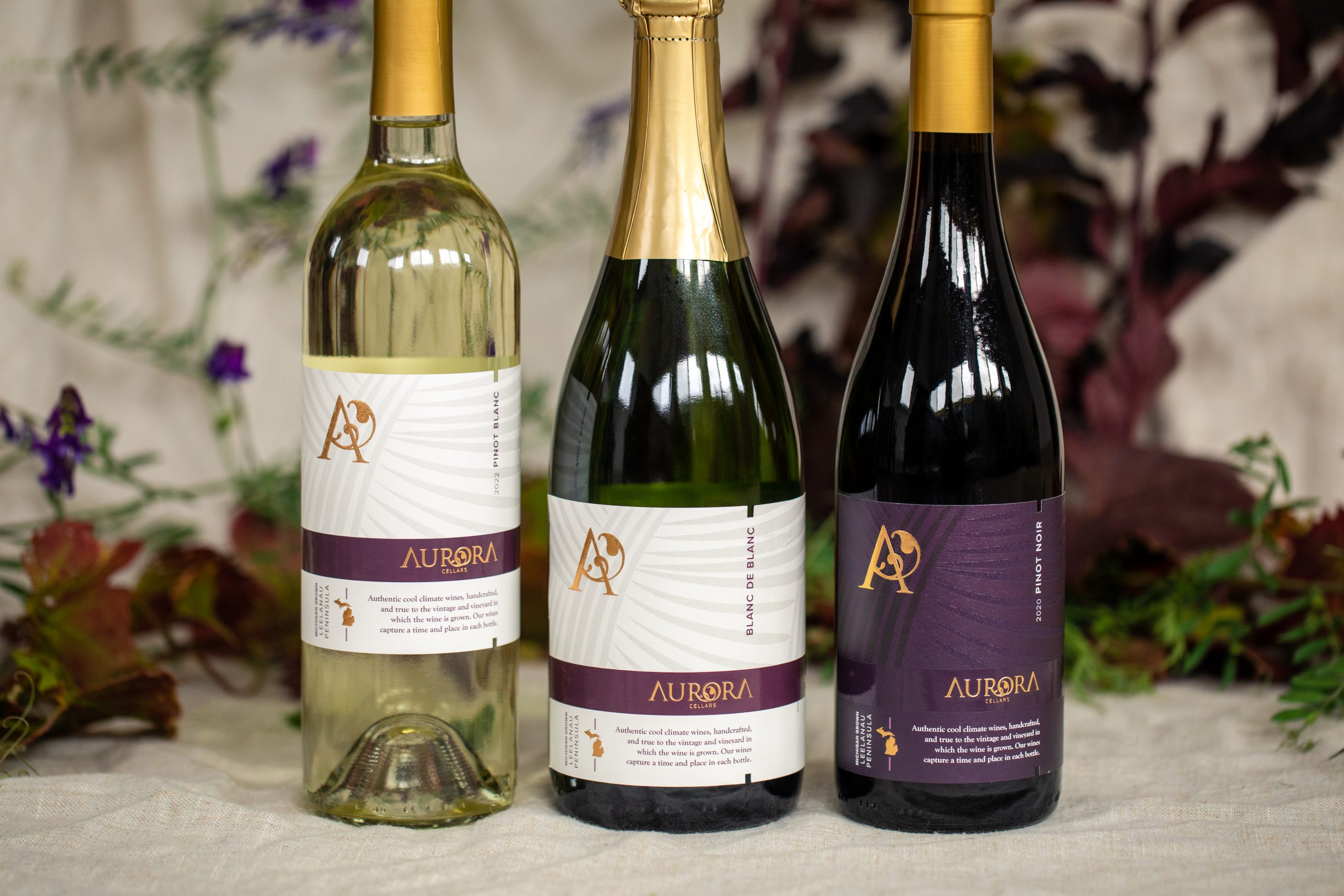 Three kinds of wine bottles from Aurora Cellars are available in Lake Leelanau, MI