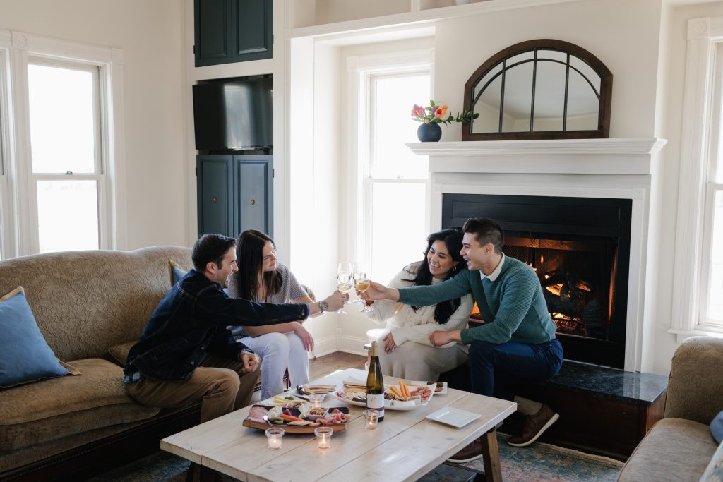 Two Couple Enjoying Aurora Cellars Wine at Their Aurora's Farmhouse in Lake Leelanau, MI